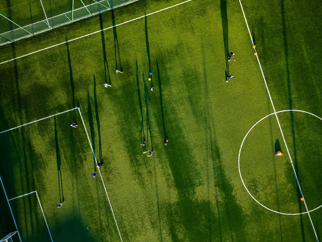 Aerial view of a line-marked sports field maintained by robotic mowing