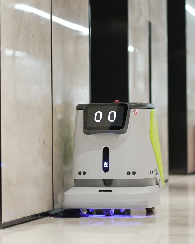 PUDU CC1 Pro cleaning outside a marble shopfront