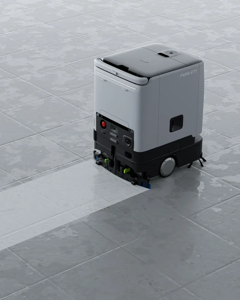 PUDU ET1 scrubbing a small-format retail floor