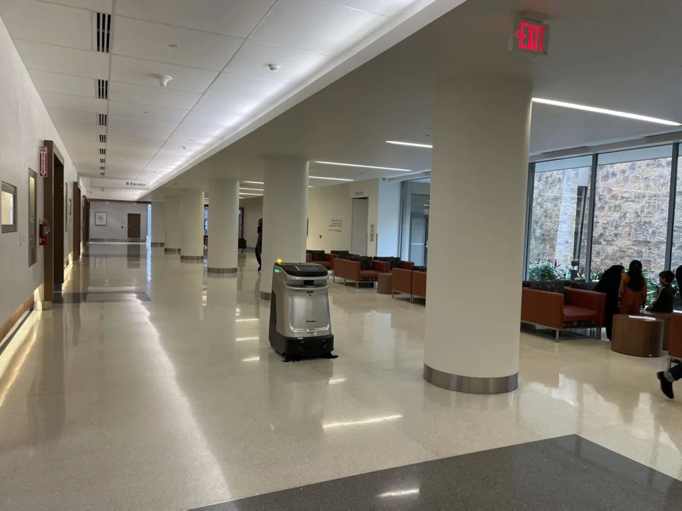 An autonomous SP50 spot cleaner in an office foyer